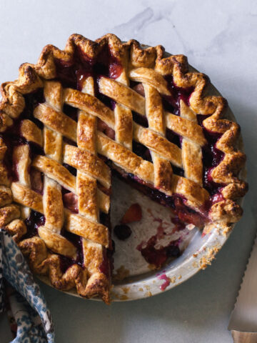 A baked blueberry peach pie with a lattice crust