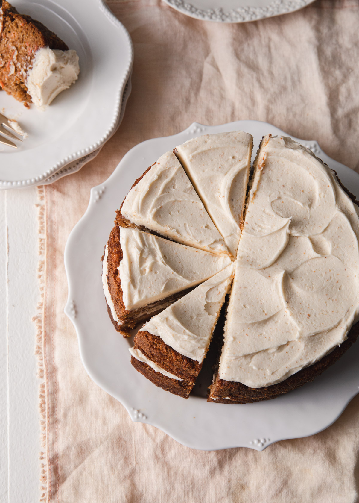 An overhead image of a carrot cake with swoops of brown butter frosting