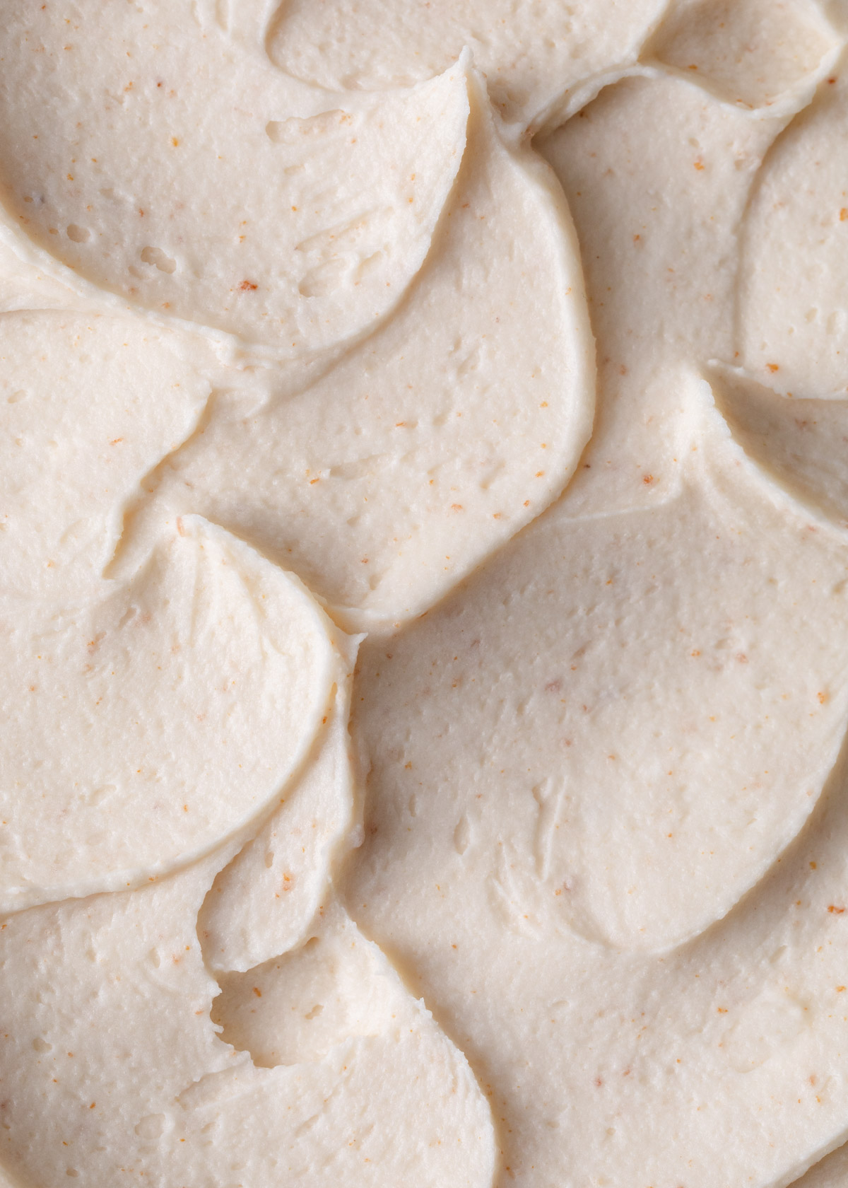 A close-up image of swirly brown butter frosting.
