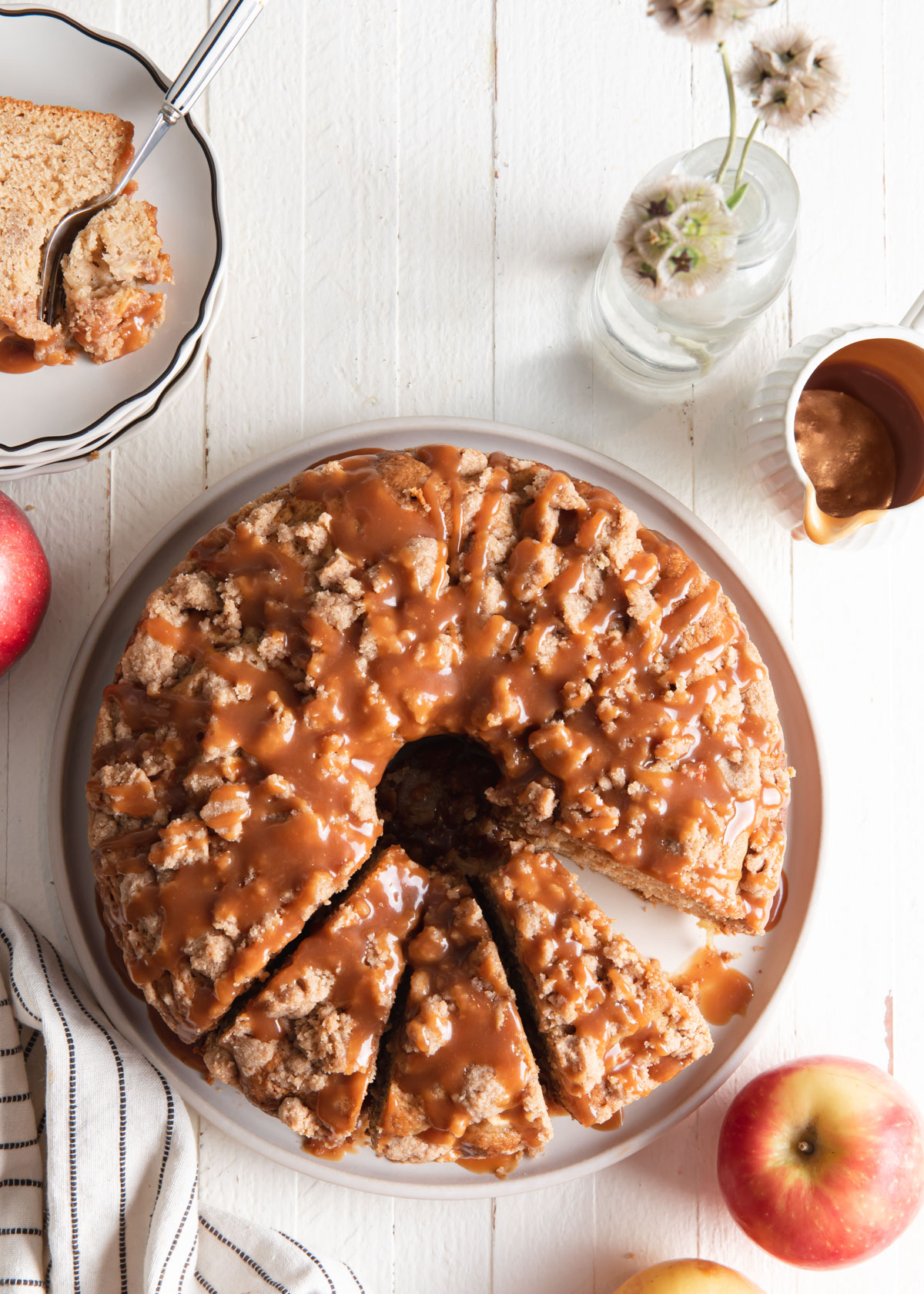 An overhead image of a caramel apple coffee cake with a few slices removed