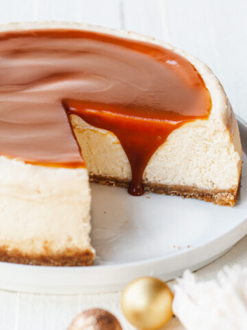 A baked cheesecake with caramel topping