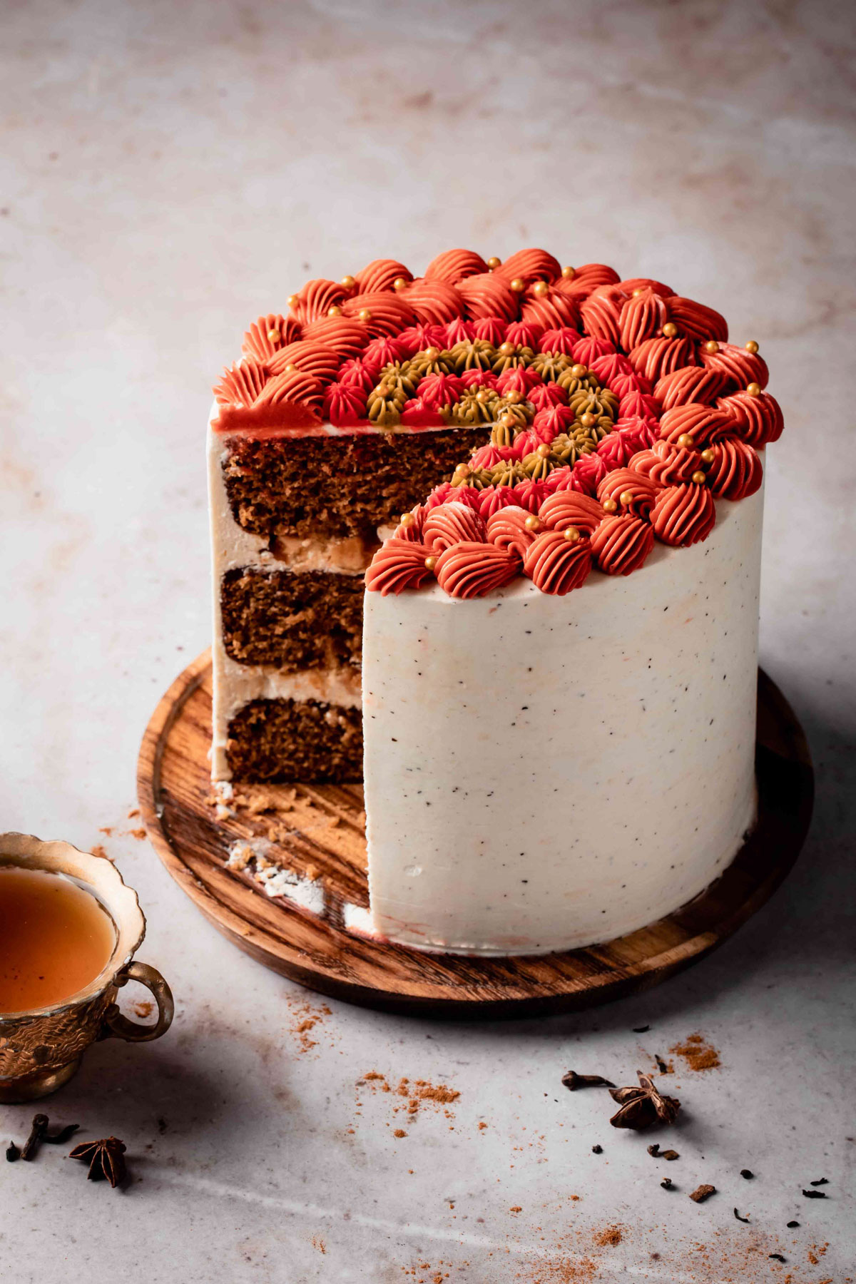 A three-layer spice cake with chai buttercream and piping on top