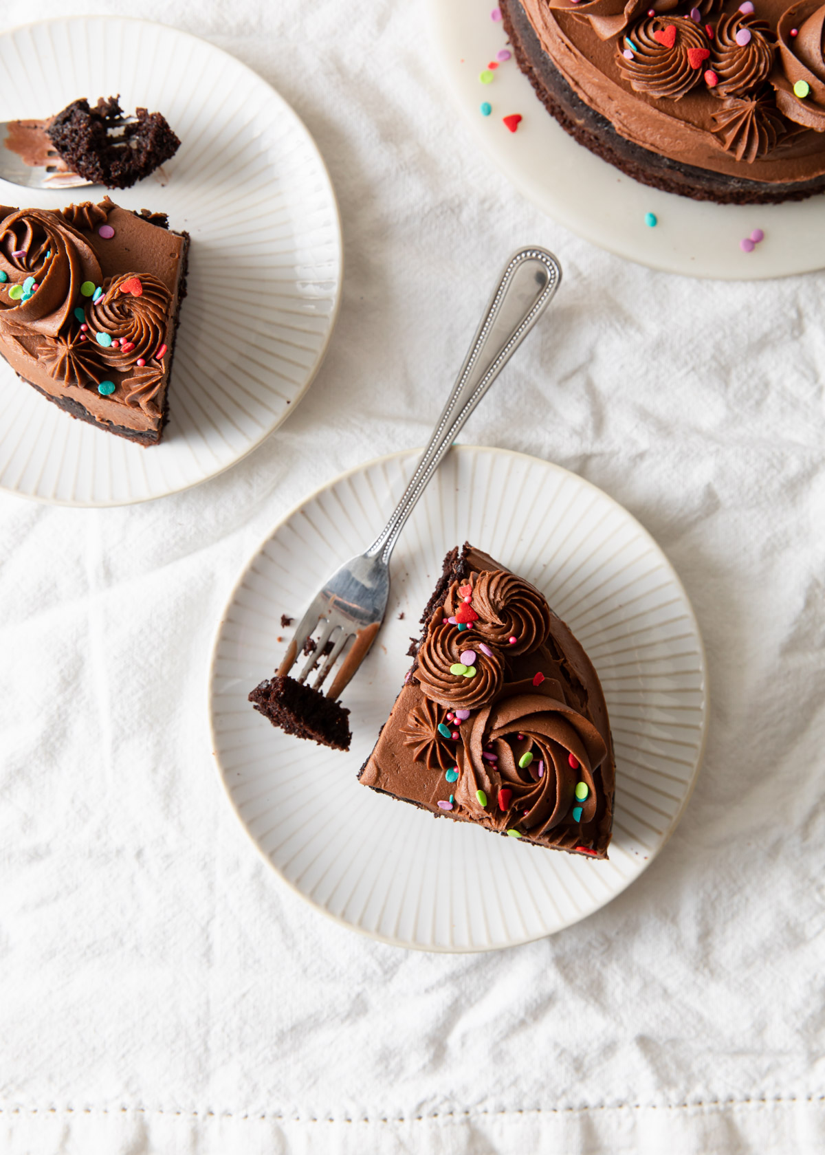 A slice of mini chocolate cake for two with fudge frosting and sprinkles