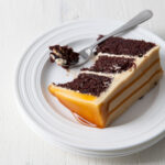 A slice of chocolate cake with caramel frosting