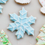 Glazed Christmas sugar cookies with sprinkles and royal icing