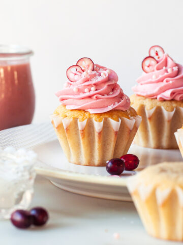 Citrus cupcakes with cranberry frosting on top