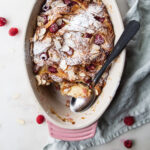 Baked croissant bread pudding with fresh raspberries and slivered almonds