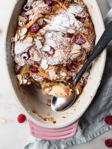 Baked croissant bread pudding with fresh raspberries and slivered almonds
