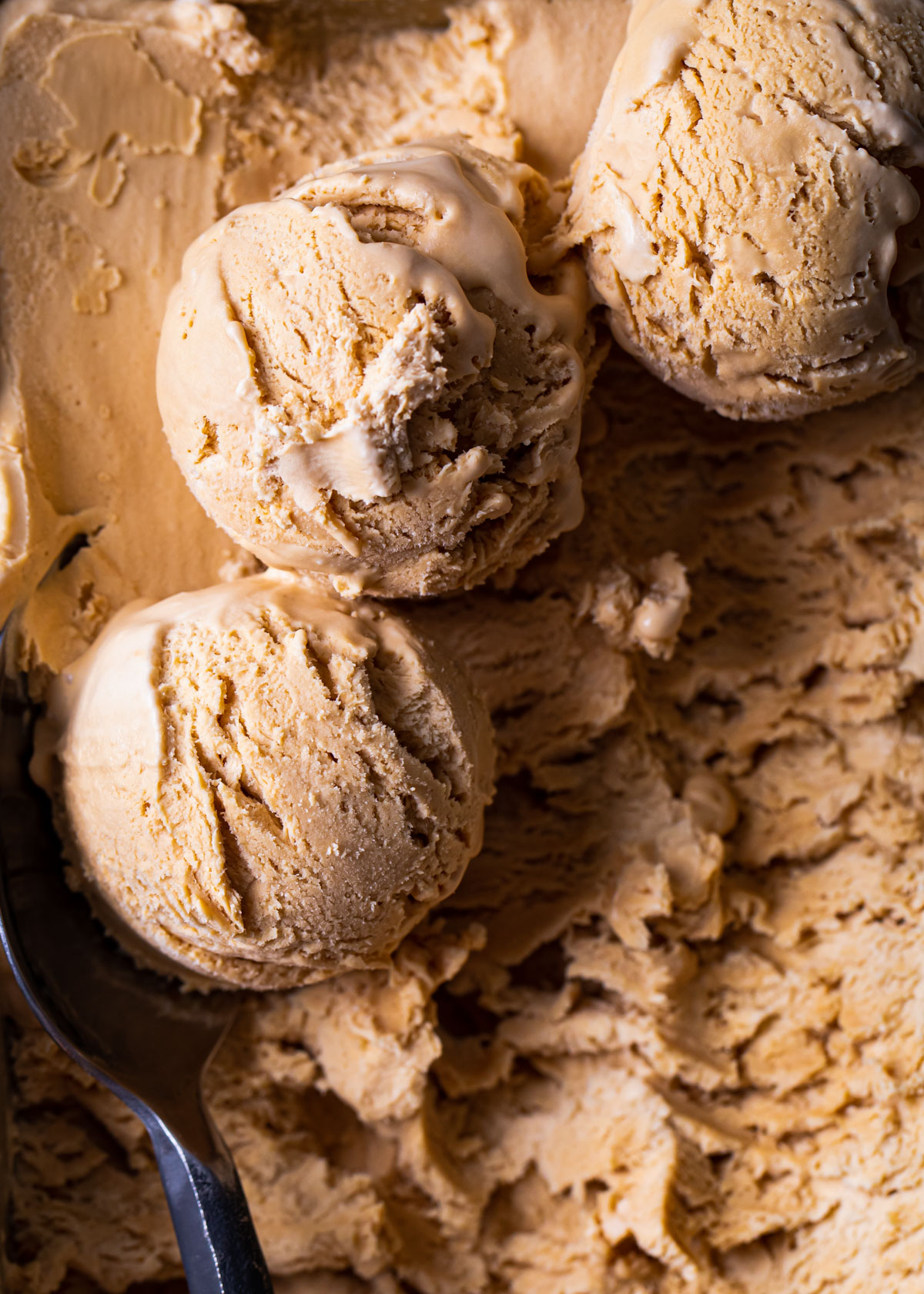 Dulce de leche ice cream scoops in their container