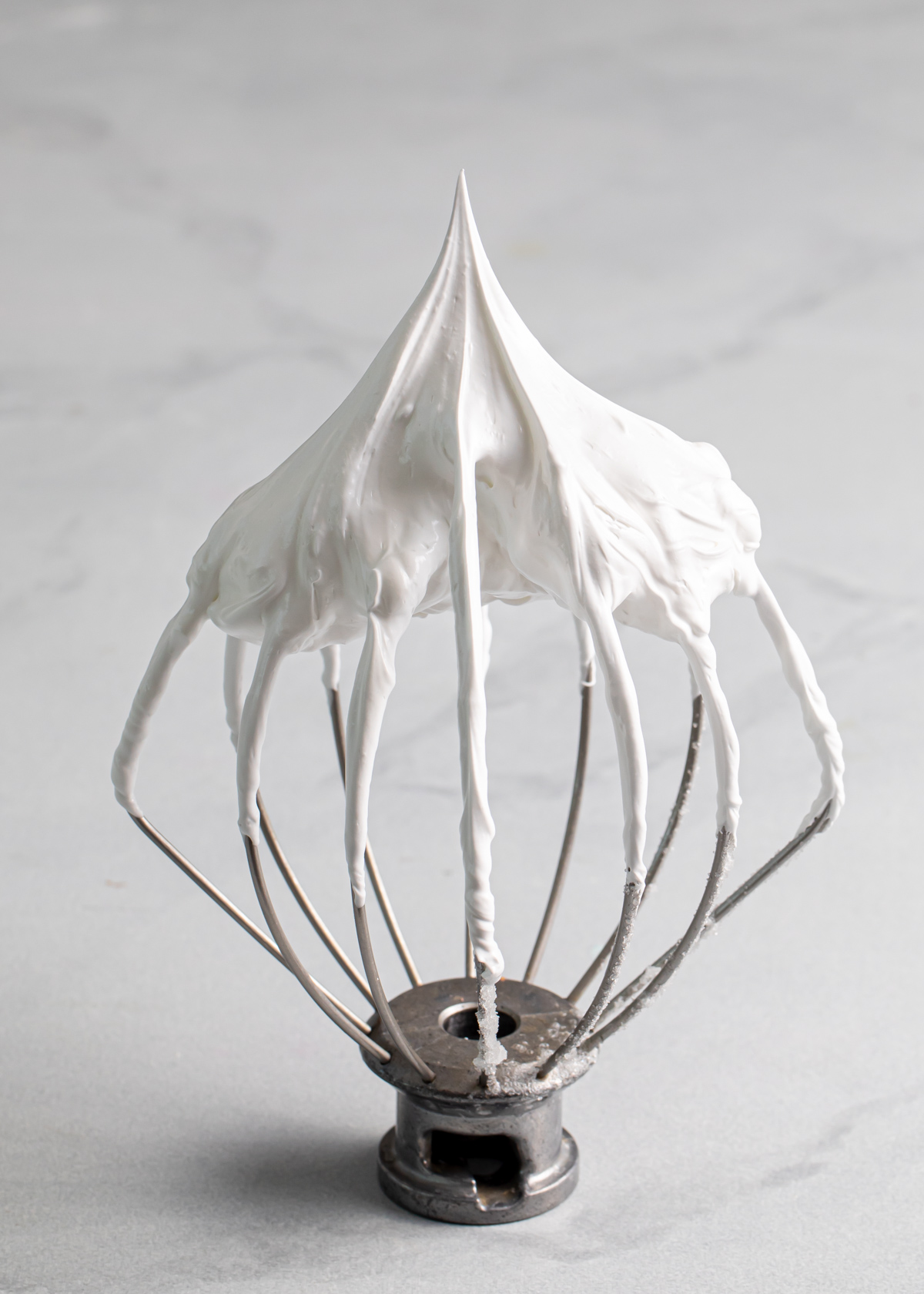 A whisk showing stiff peaks of French meringue