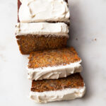 slices of honey carrot banana bread with cream cheese frosting