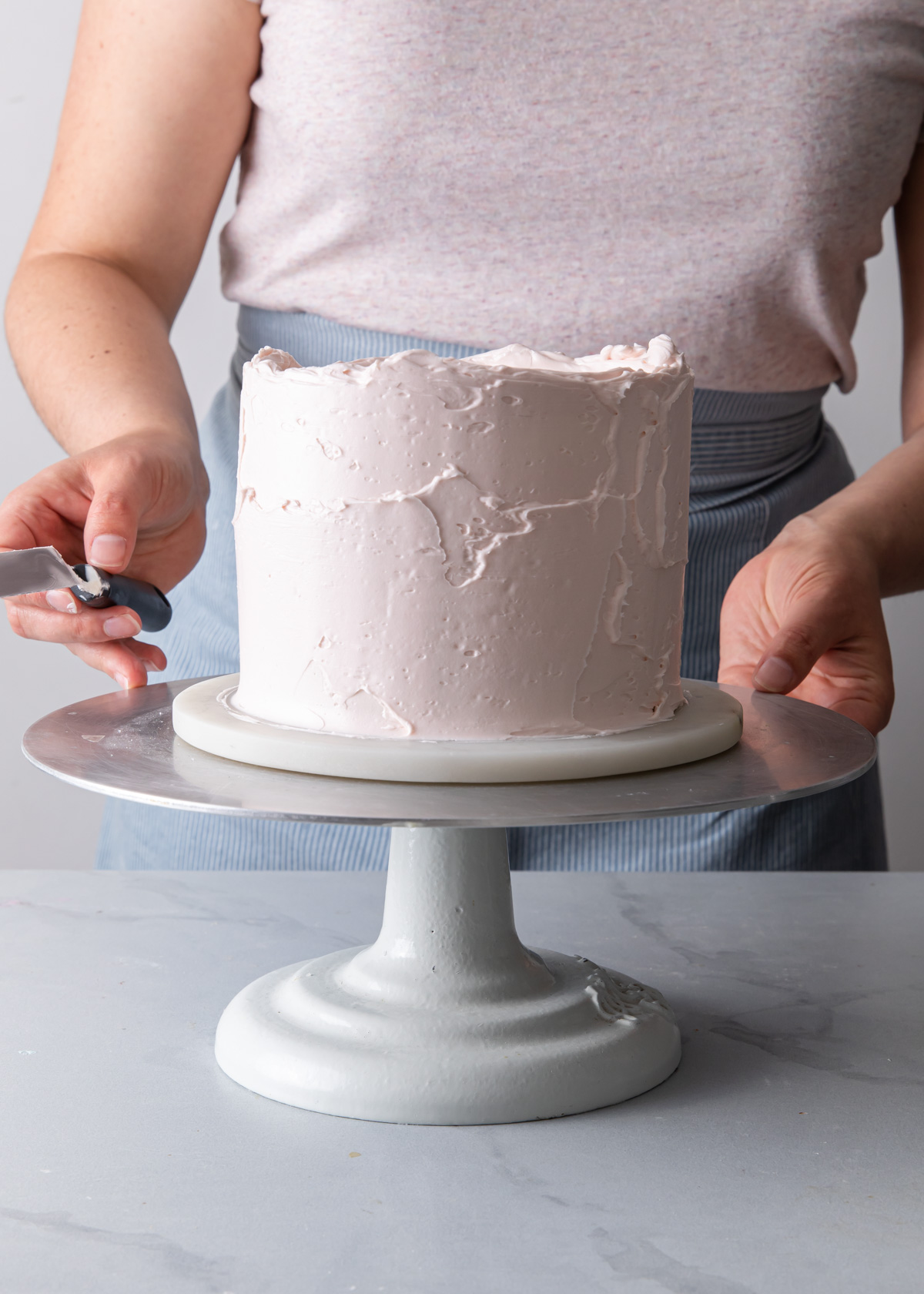 A cake frosted with pink buttercream