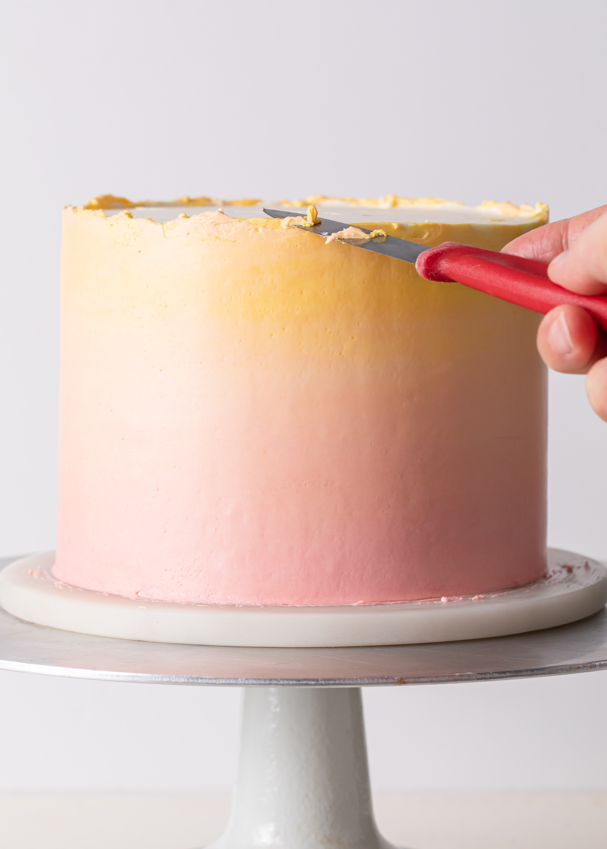 Trimming the top of an ombre cake