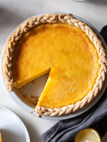 A baked lemon chess pie with a braided crust border