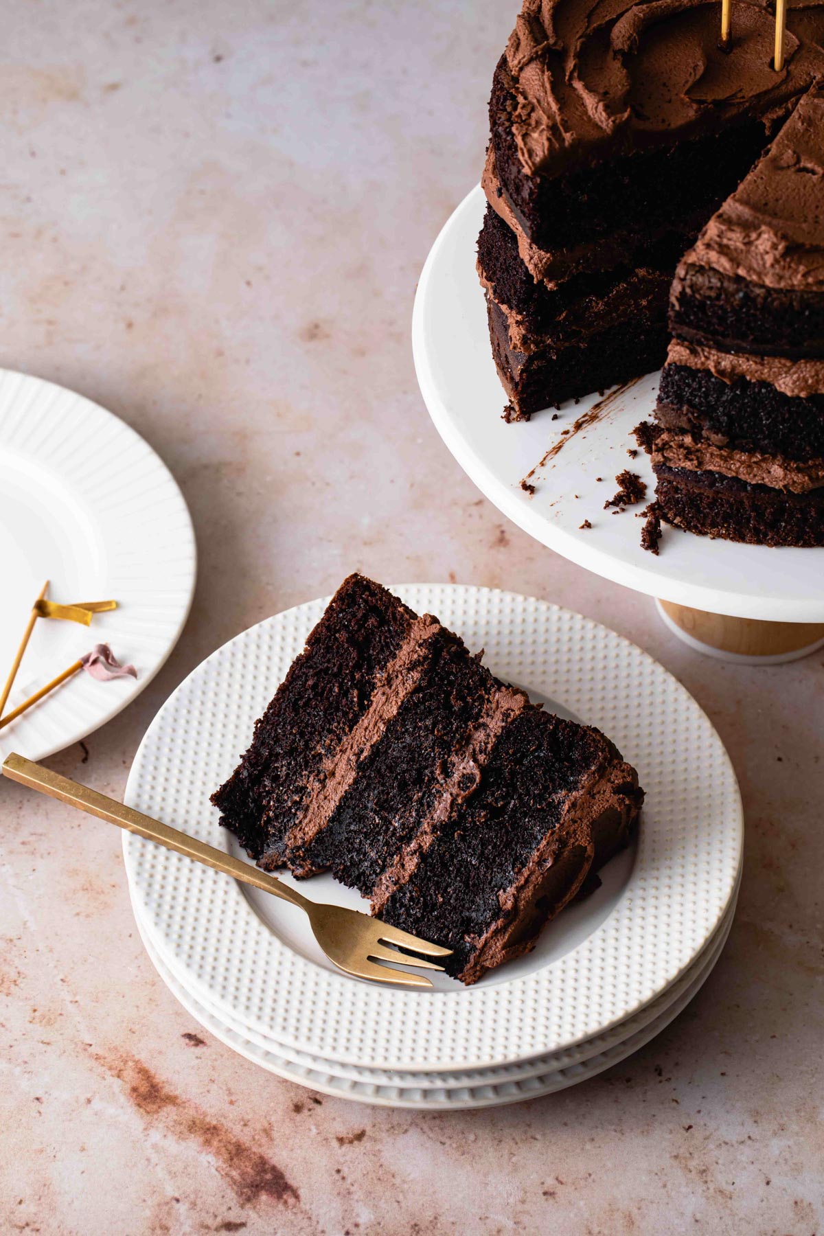 A thick slice of a three-layer moist chocolate cake