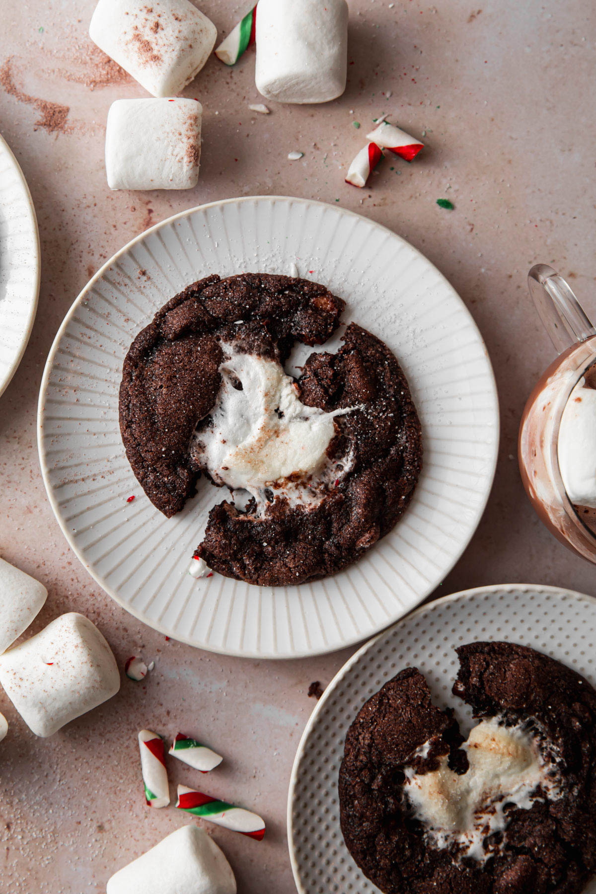 Overheard image of peppermint hot chocolate cookies with marshmallows and hot cocoa sprinkled in the background