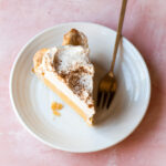 A slice of pumpkin chiffon pie with whipped cream topping