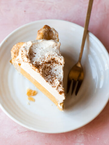 A slice of pumpkin chiffon pie with whipped cream topping