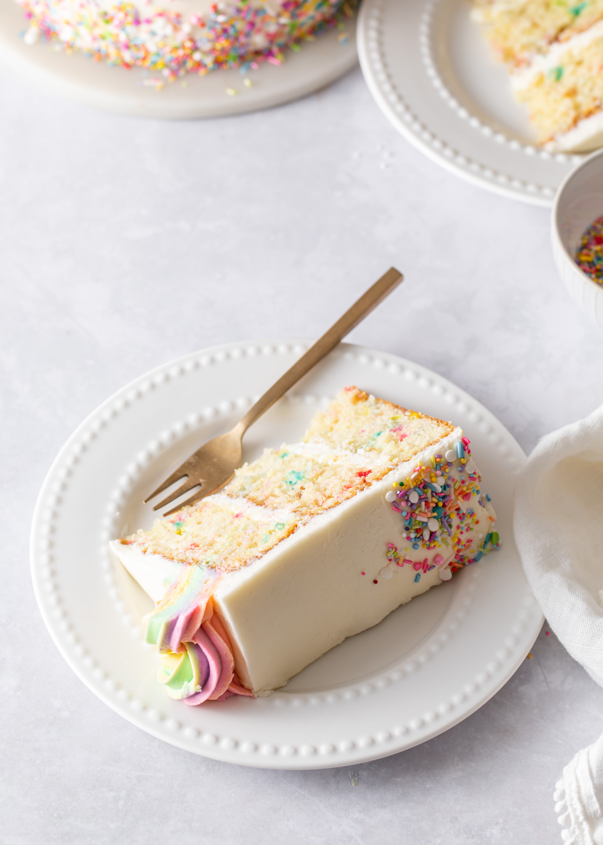 A slice of rainbow sprinkle cake