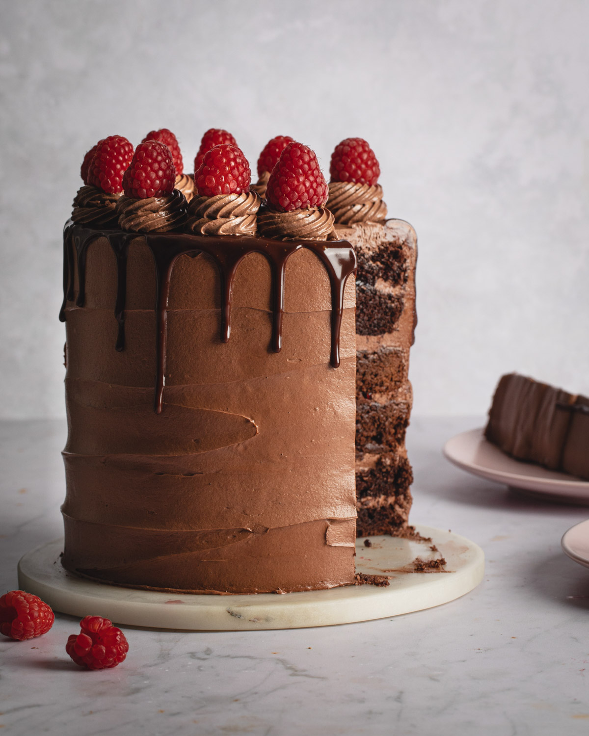 A Nutella cake with brownie and chocolate cake layers and raspberry jam