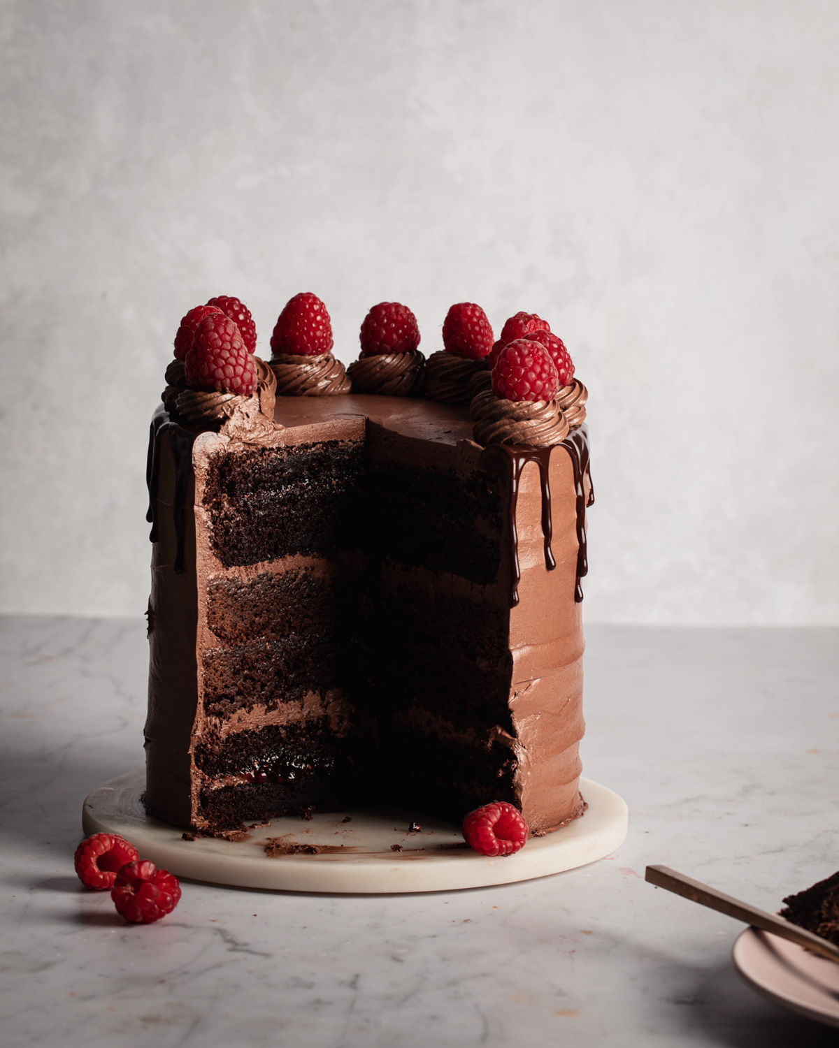 A Nutella cake with brownie and chocolate cake layers and raspberry jam