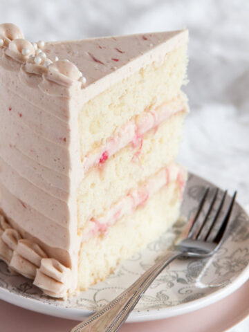 A slice of rhubarb ginger cake with pink frosting