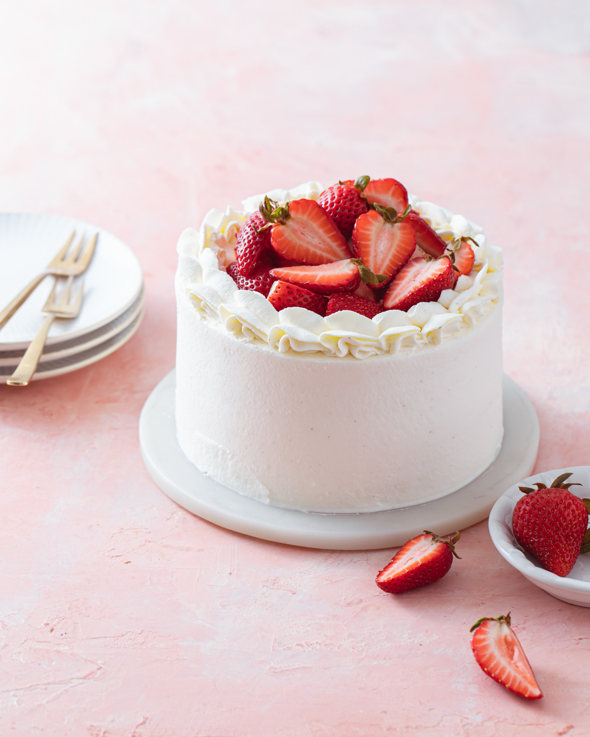 A mini strawberry chiffon cake iced in whipped cream