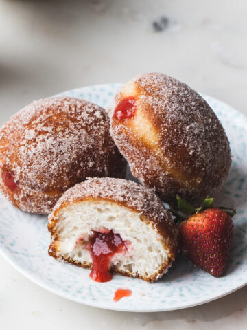 A plate of strawberry rhubarb filled donuts