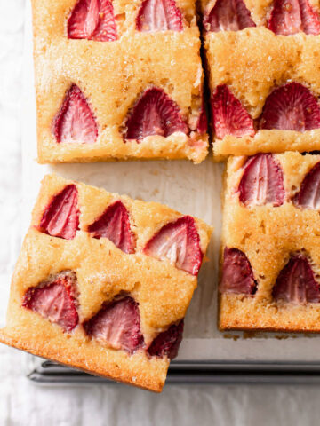 Slices of cake with strawberries baked on top