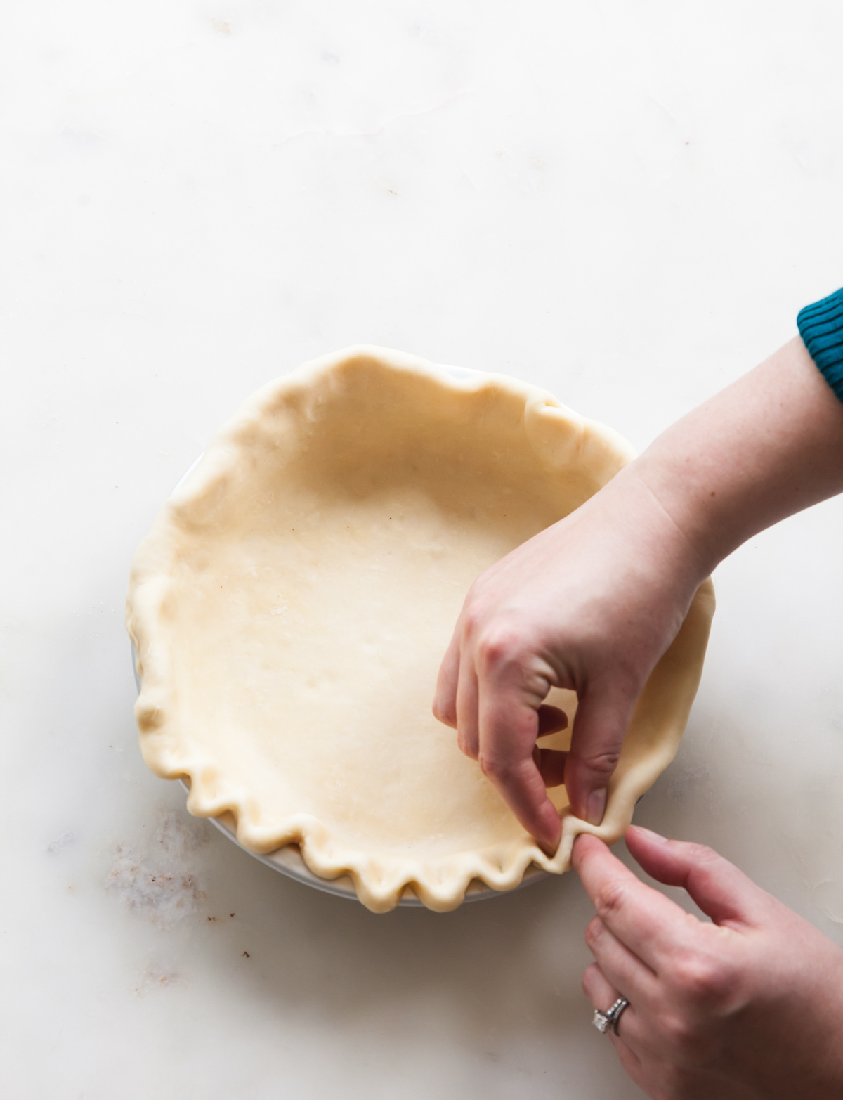 Crimping the edge of a an unbaked pie