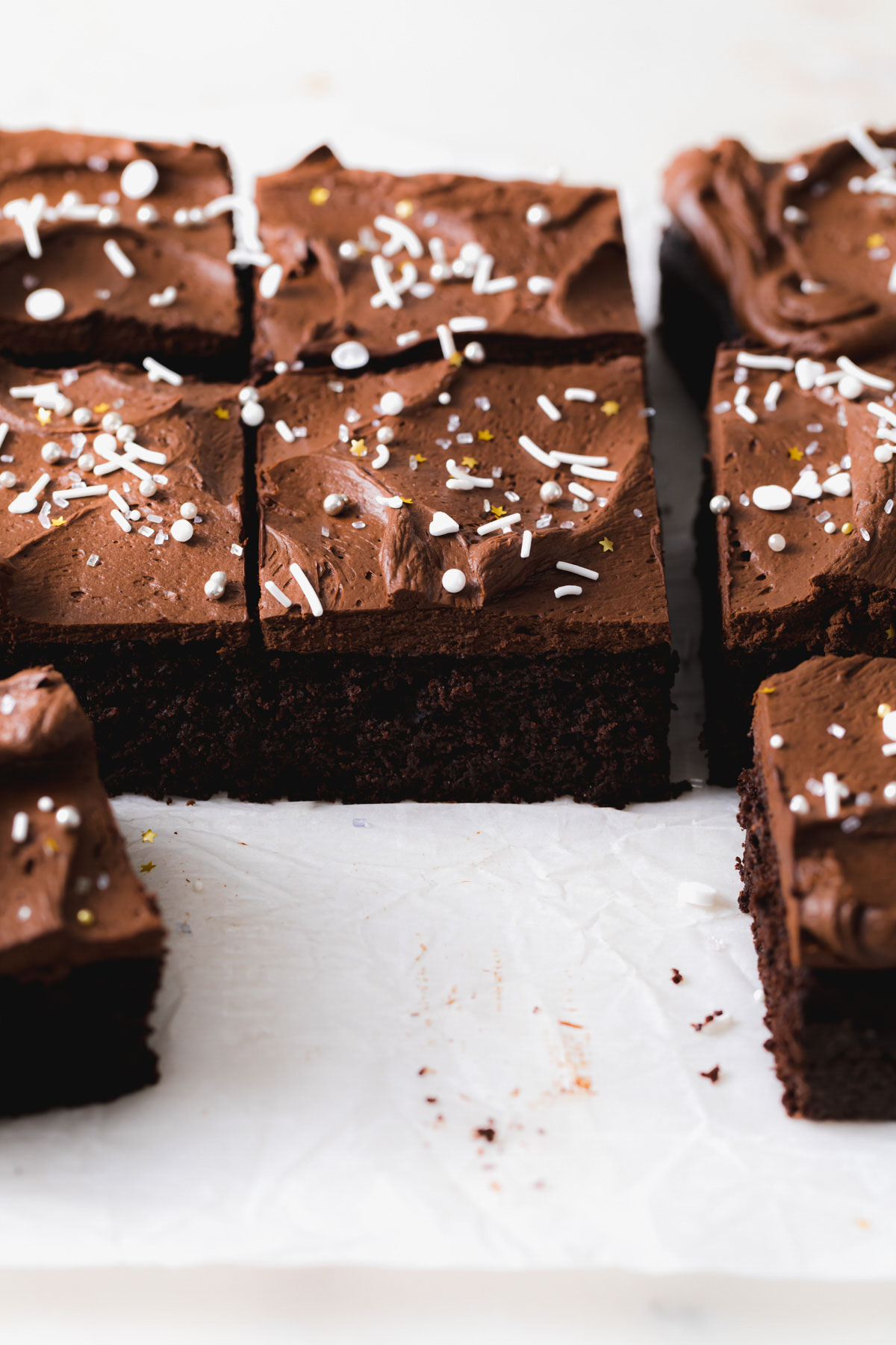 Squares of chocolate snack cake with sprinkles on top