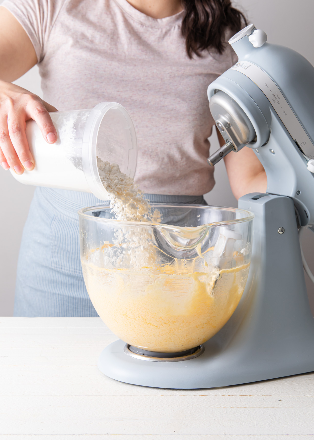 Adding flour to cake batter
