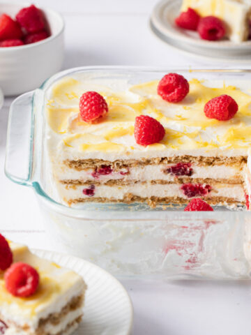 Layers of whipped cream, lemon curd, and graham crackers in an icebox