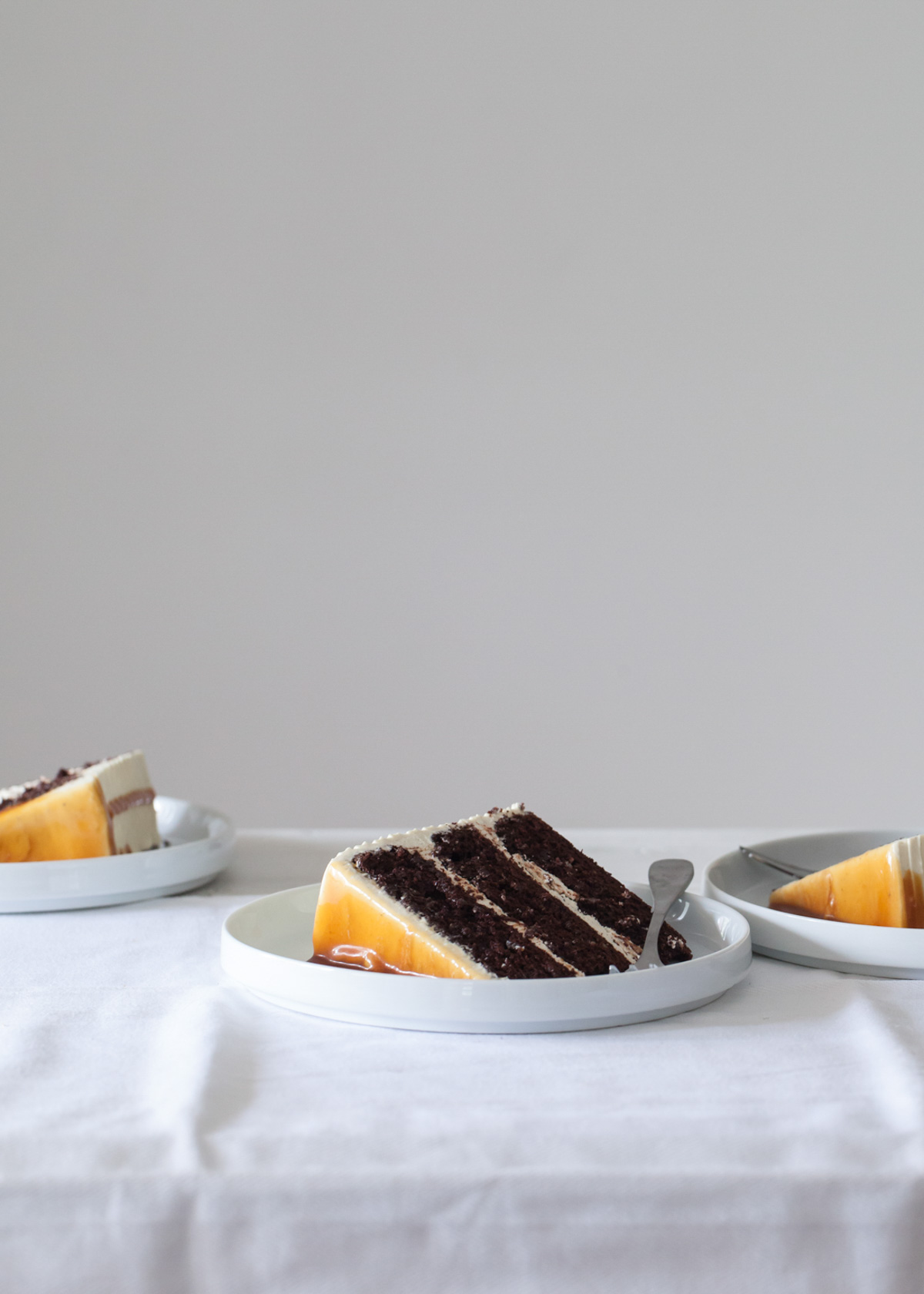 A slice of chocolate layer cake with caramel on the outside