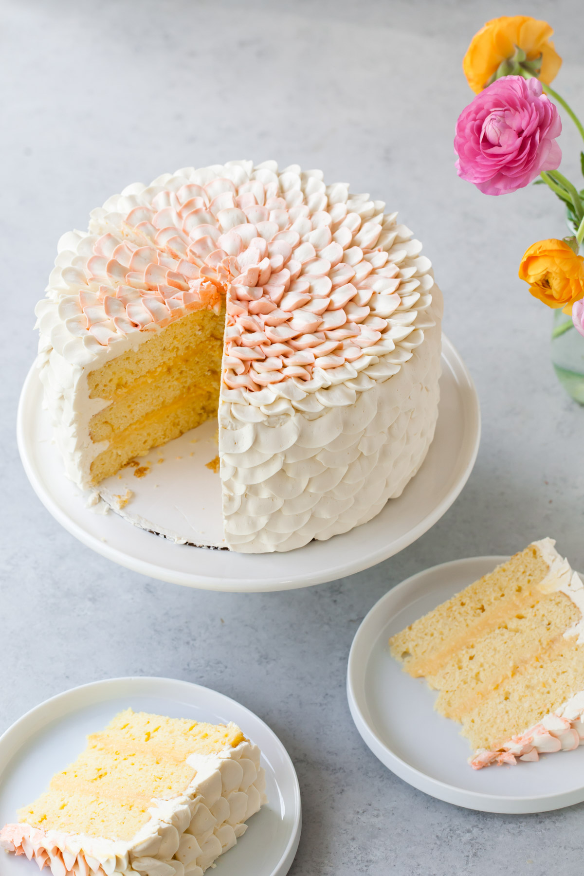 Piped petal buttercream all over an orange salted honey cake