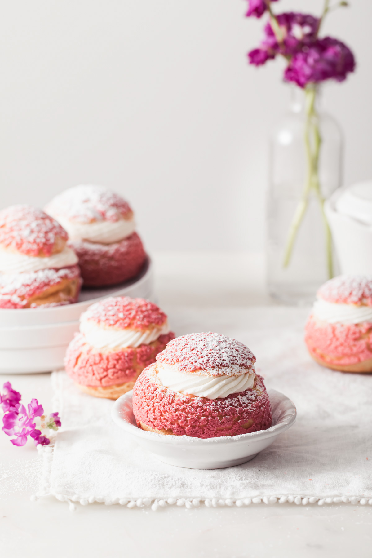 Pink raspberry choux buns with rose cream