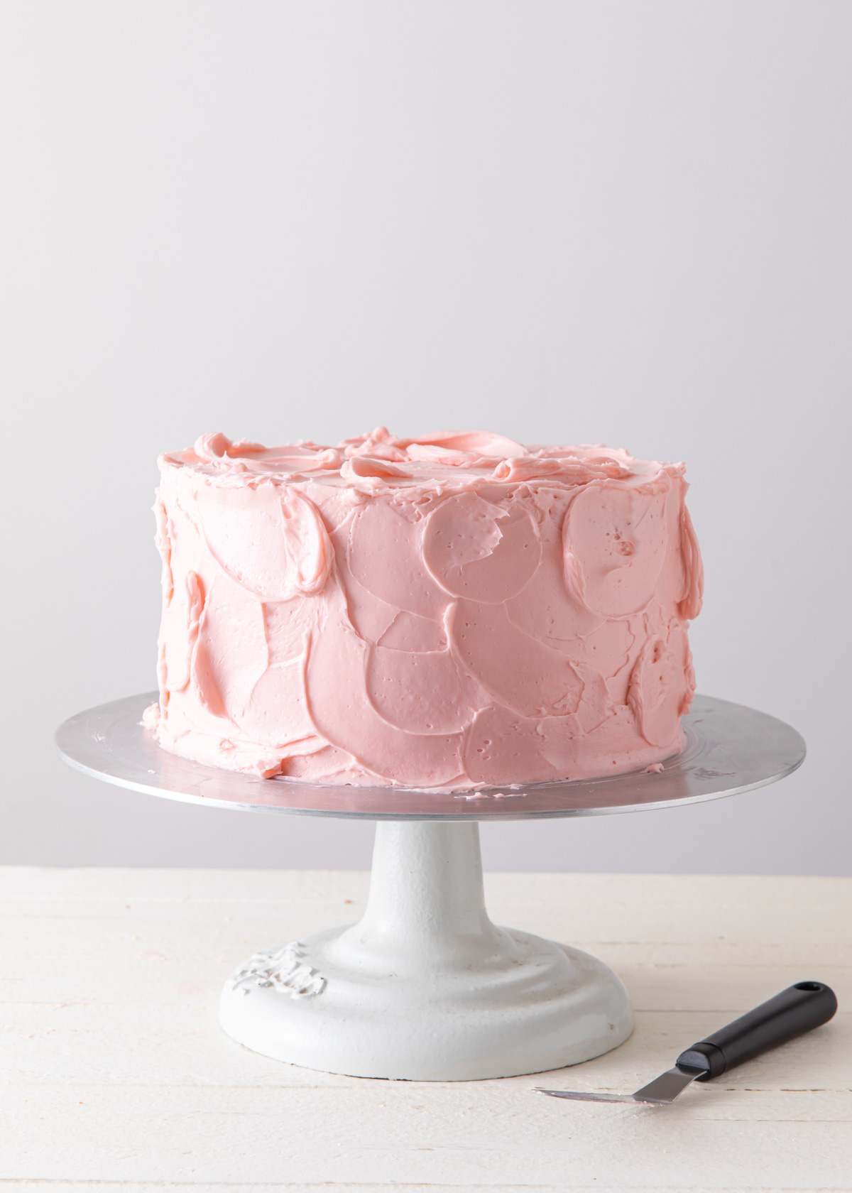 A pink rustic buttercream cake