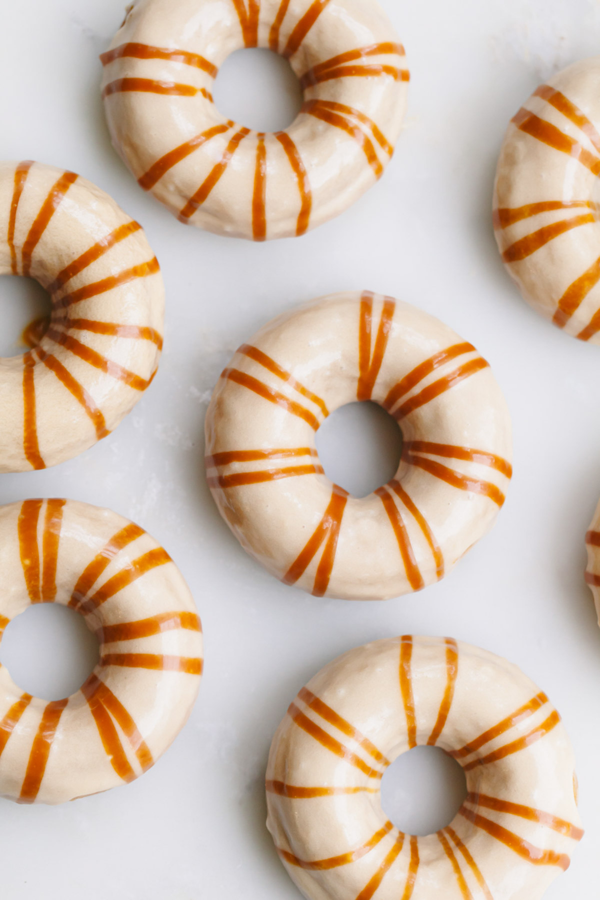 An overhead image of pumpkin donuts with salted caramel glaze