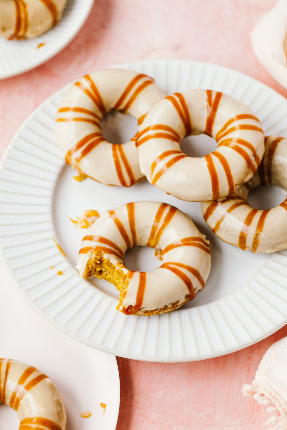 A plate of pumpkin donuts with caramel glaze on top