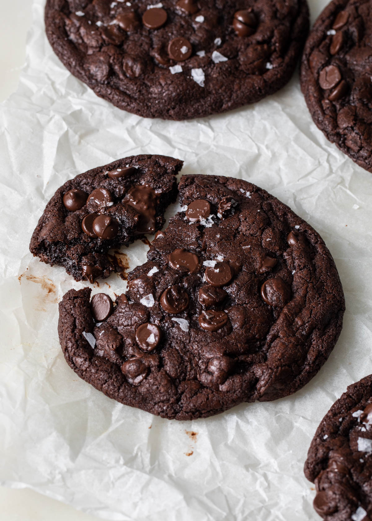 A giant double chocolate chip cookies with melted chocolate chips and flaky sea salt