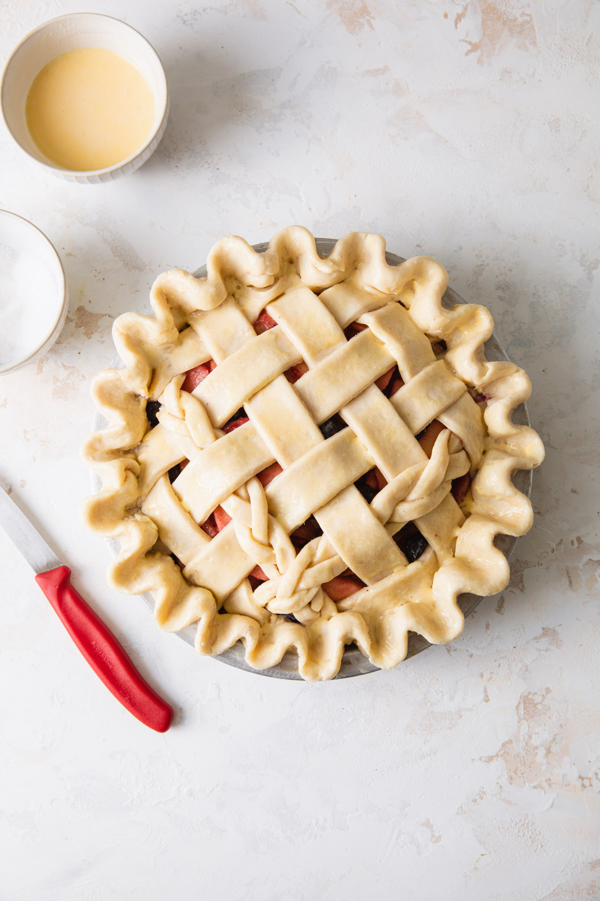 A lattice pie with egg wash on top before baking
