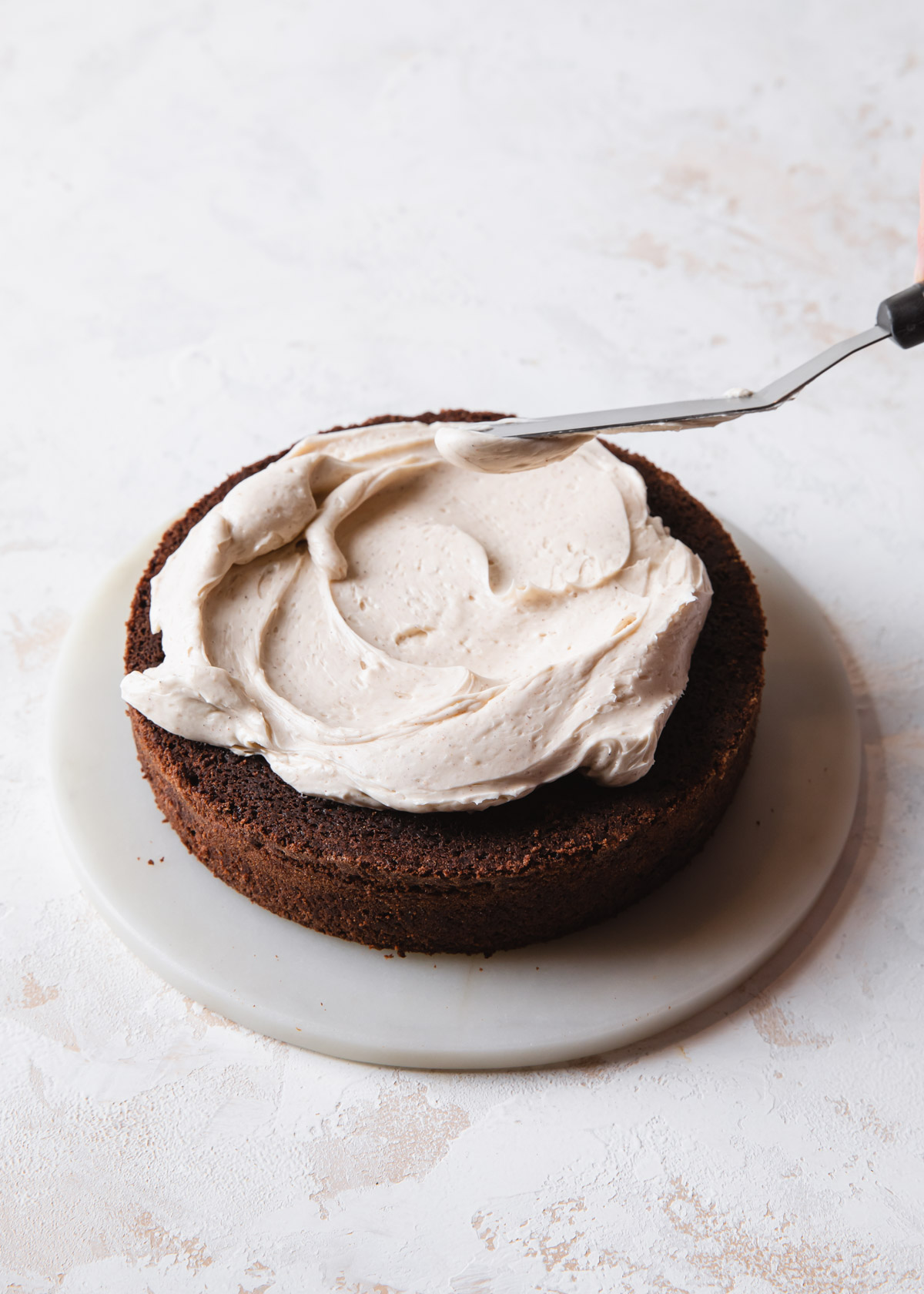 Frosting a brownie layer cake