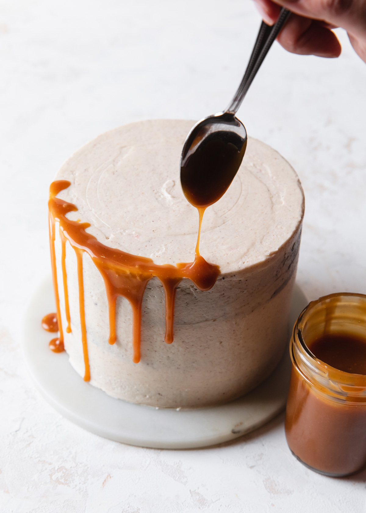 Caramel being drizzled onto a cake