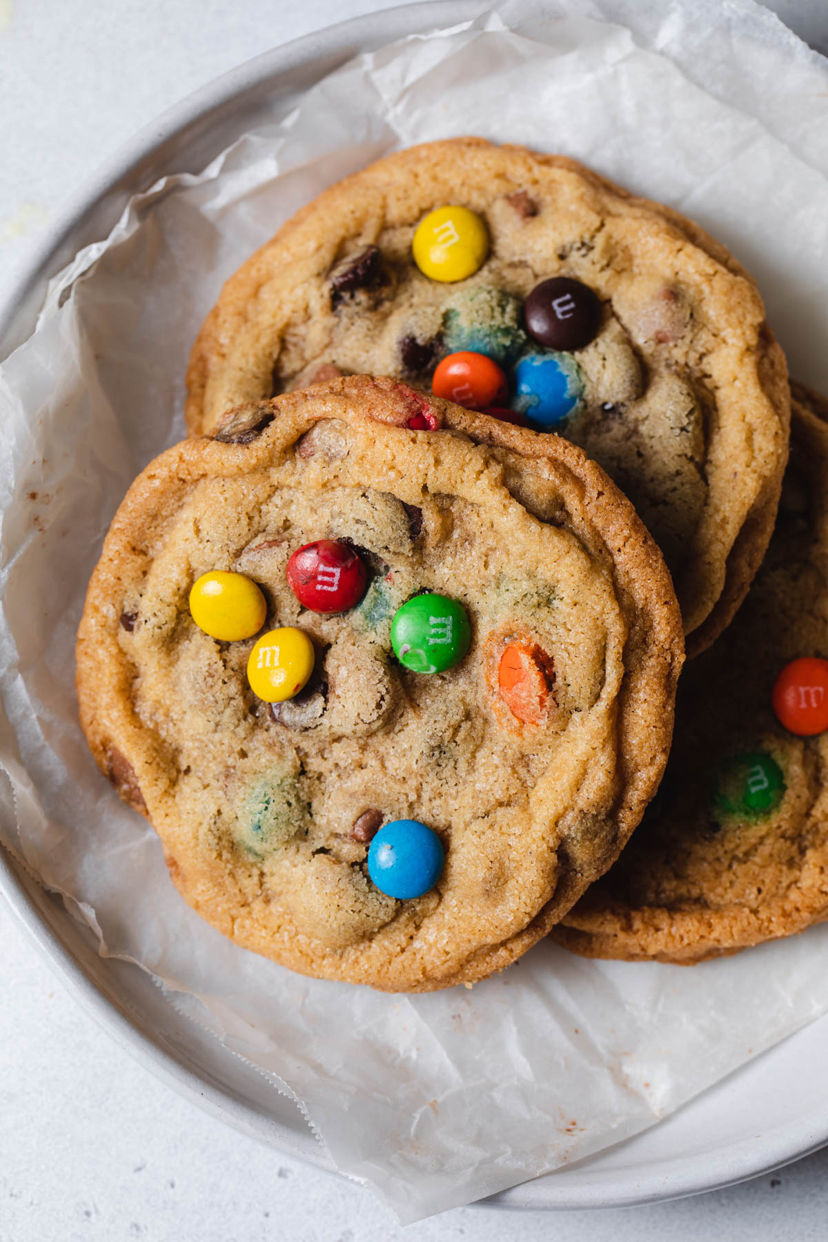A plate of rainbow m and m crispy chocolate chip cookies