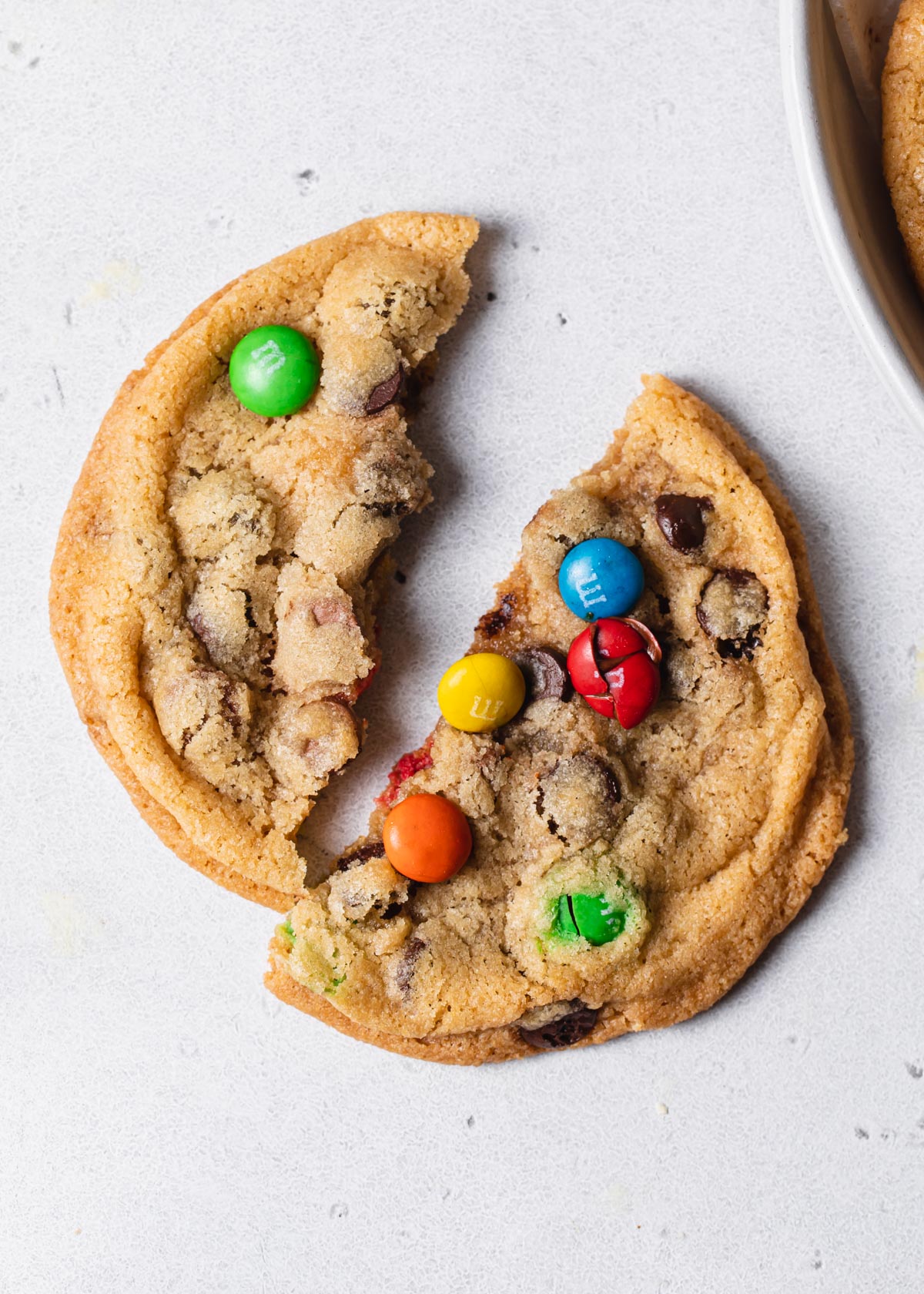 a baked crispy chocolate chip cookies with rainbow M and M's on top
