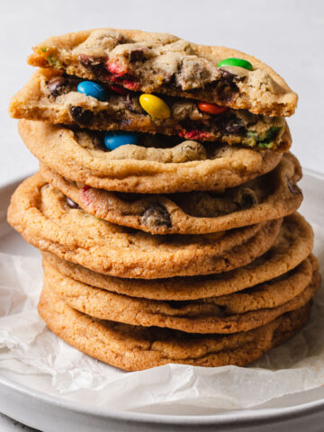 A stack of Crispy chocolate chip cookies with rainbow m and m's