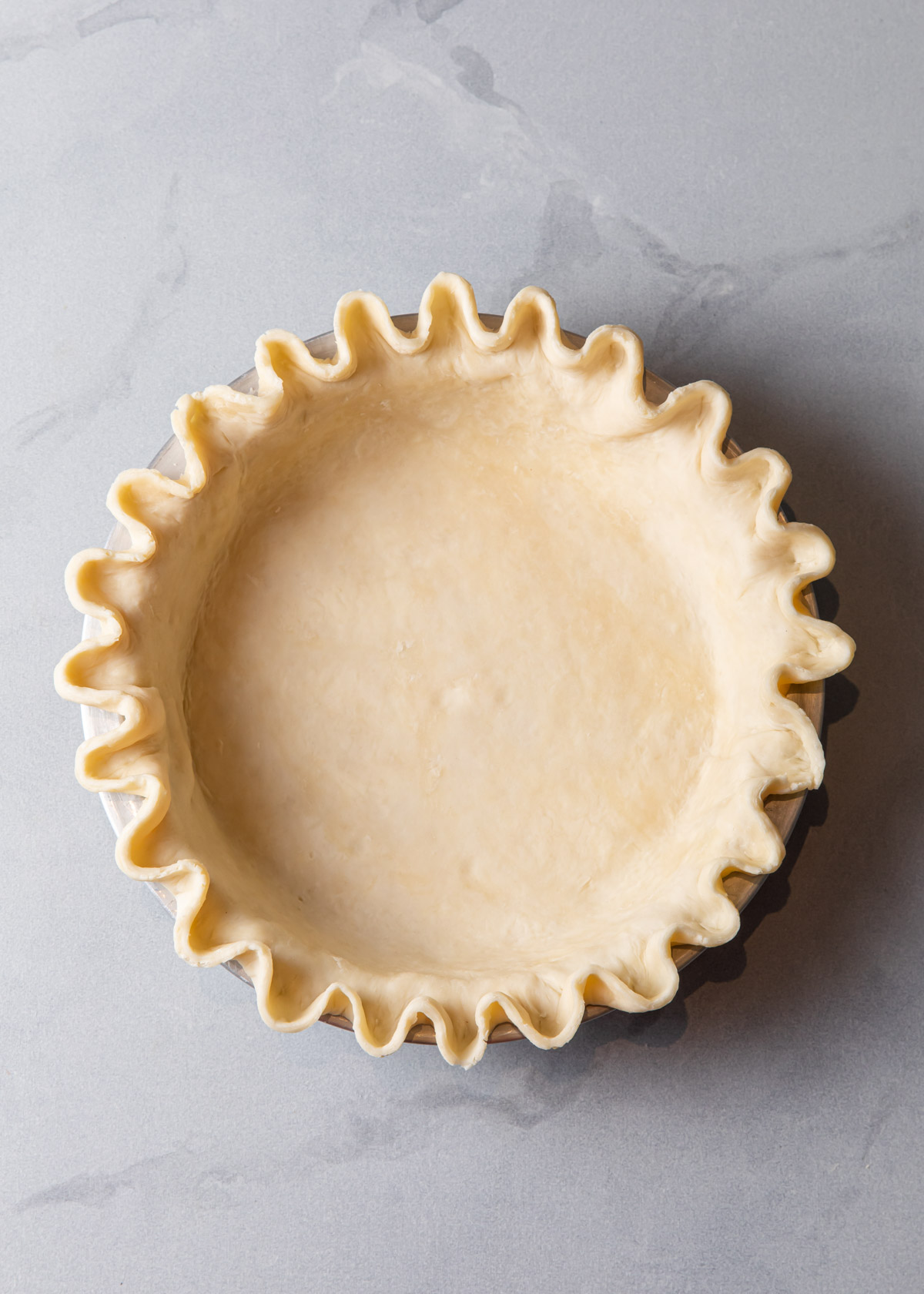 A crimped pie shell before baking.