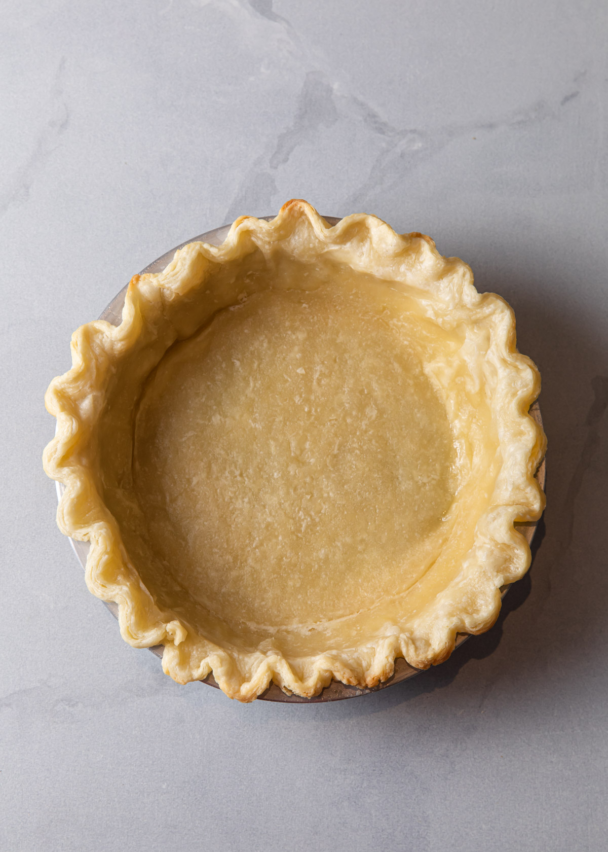 A partially baked pie crust