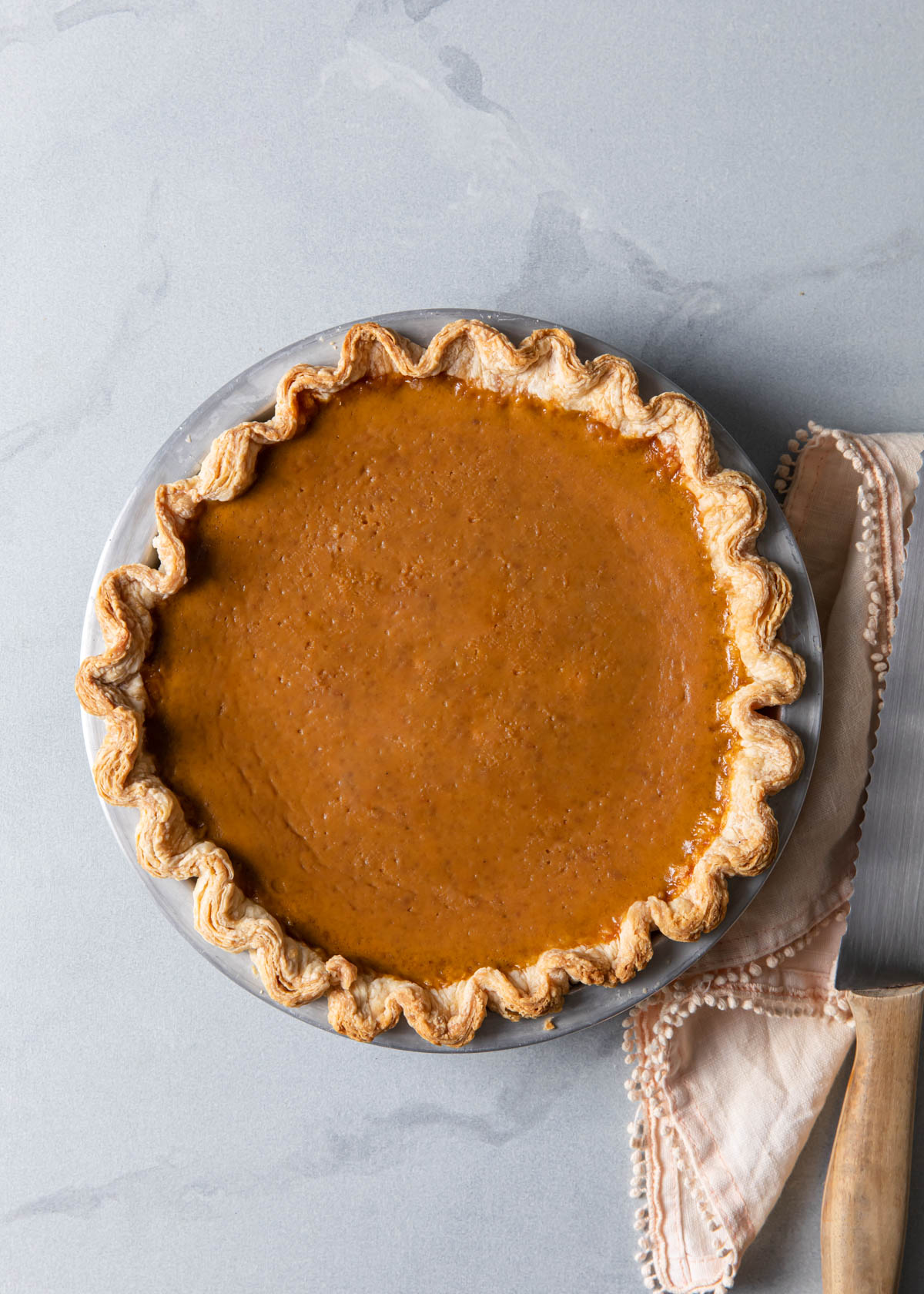 A baked pumpkin pie straight from the oven.