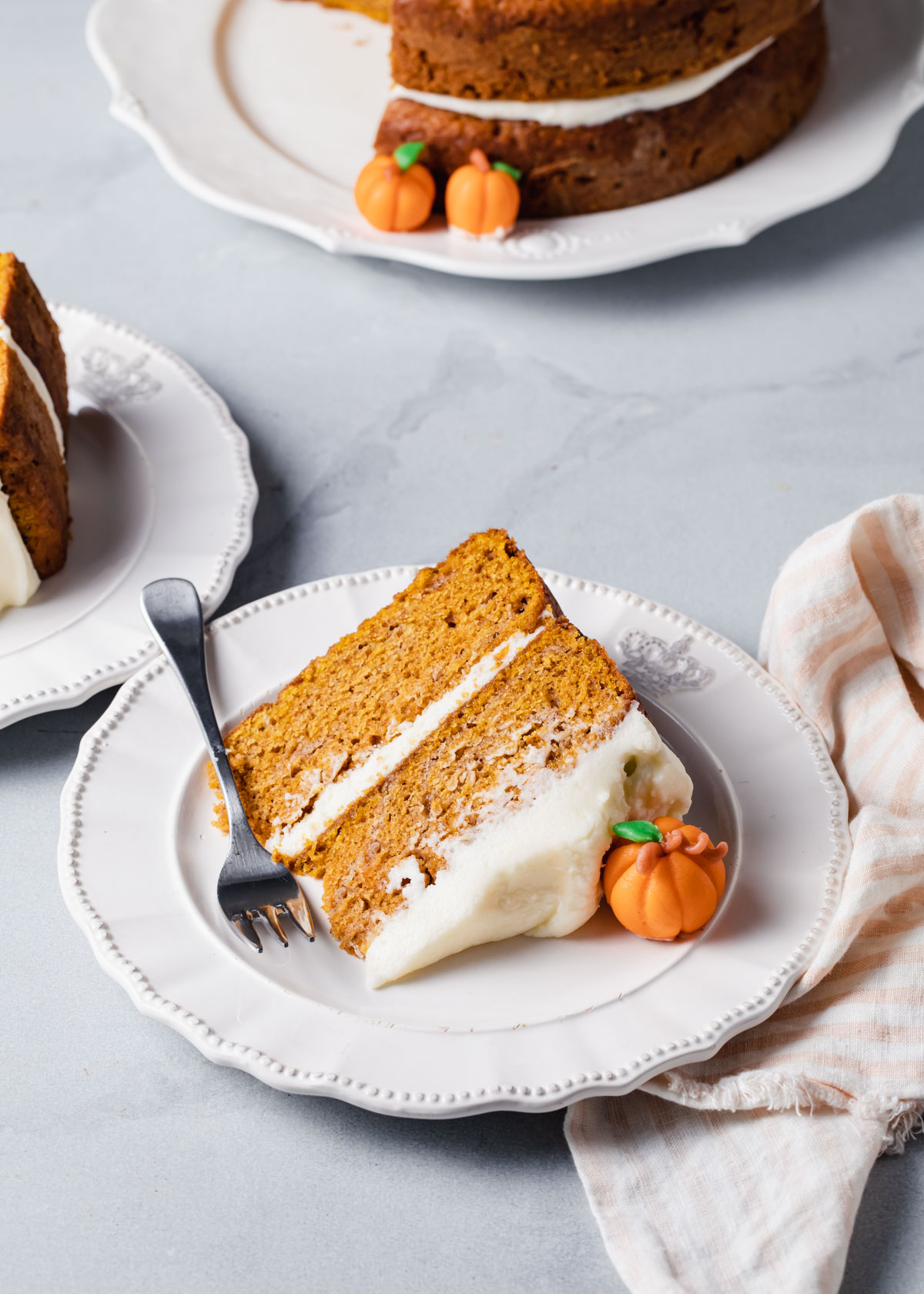 A slice of maple pumpkin cake on a white plate